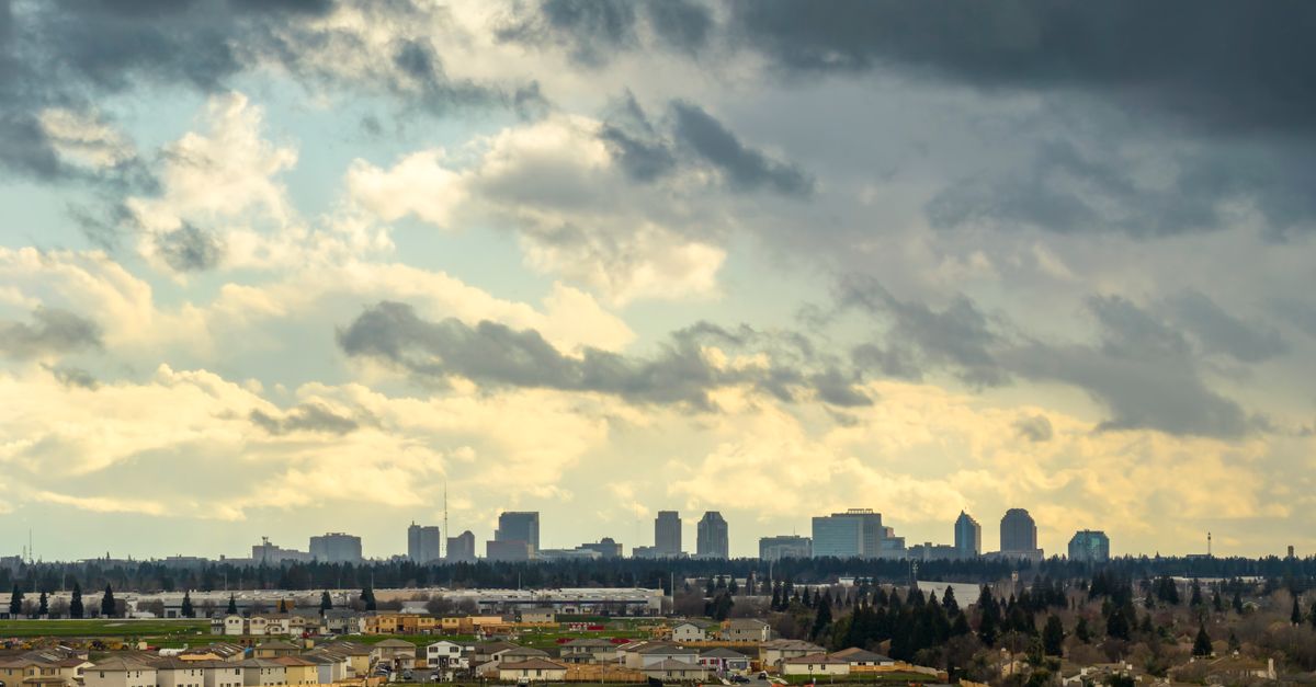Scenic view of Sacramento's skyline with dramatic clouds in the background, highlighting the transitional weather.